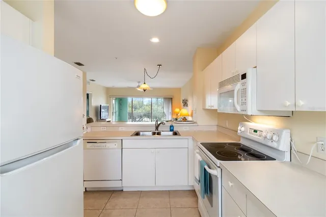 a kitchen that has a sink and a stove in it