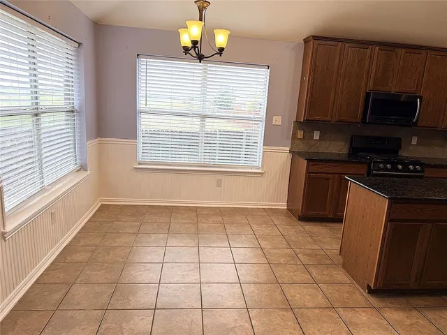 a kitchen with a stove a sink and a microwave