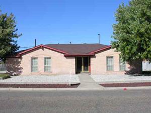 3304 Mockingbird Lane Amarillo, TX 79109 - Photo 1 of 1 a front view of a house with a yard and garage