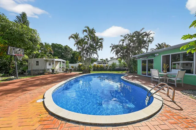 a view of a swimming pool with sitting area