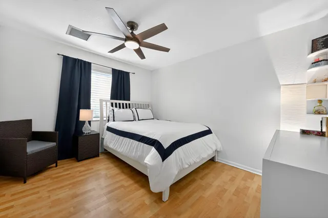 a bedroom with a bed and wooden floor