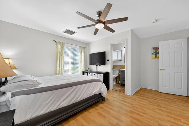 a bedroom with a bed and a flat screen tv