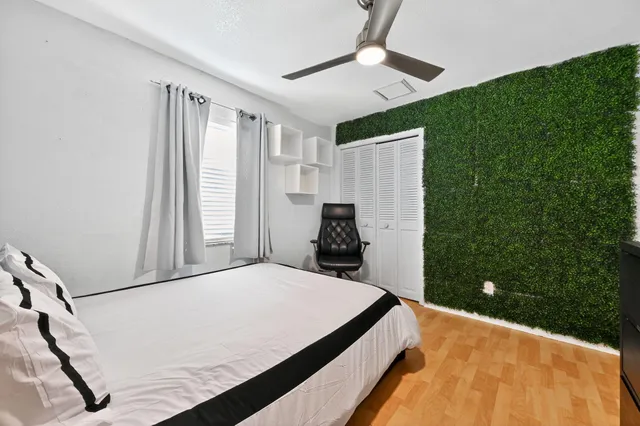 a bedroom with a bed and a chandelier