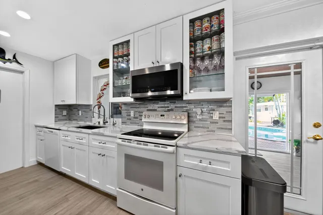 a kitchen with stainless steel appliances a stove and a microwave