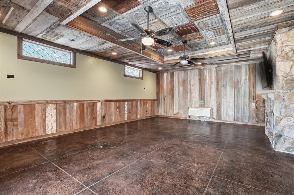 2133 Rustic Ridge Drive Keller, TX 76248 - Photo 33 of 40 Spare room with wooden walls, recessed lighting, ceiling fan, and a raised ceiling