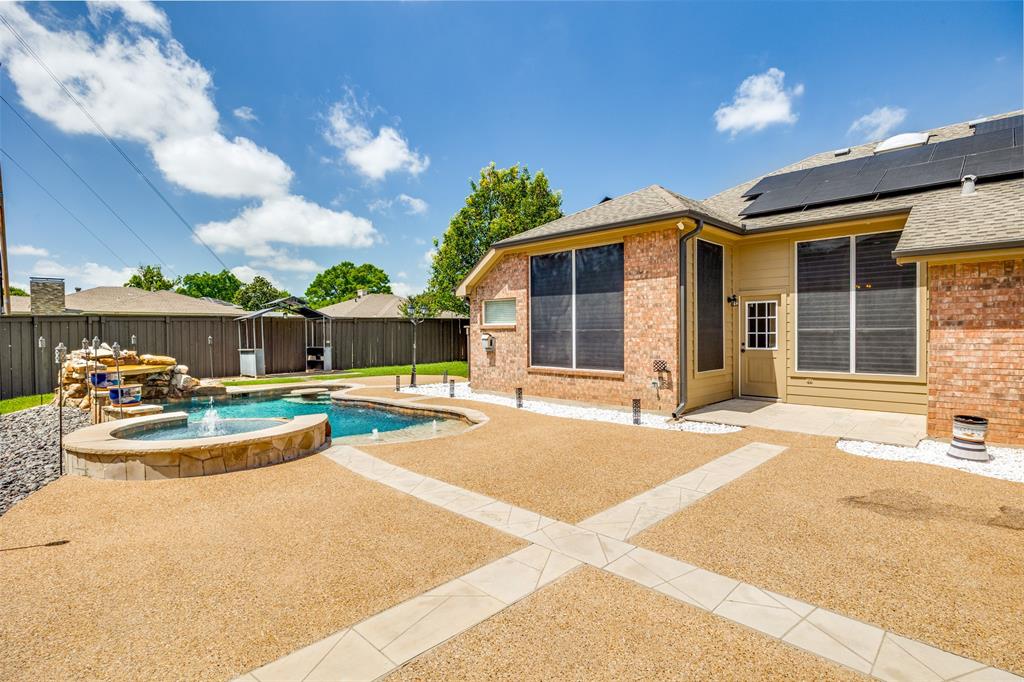 2100 Los Rios Boulevard Plano, TX 75074 - Photo 23 of 25 Backyard featuring a custom-shaped pool with an integrated spa and rock waterfall