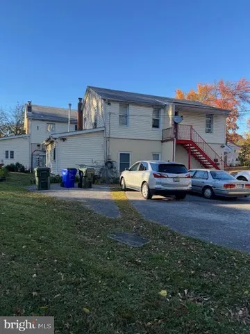 a view of a field of grass and trees