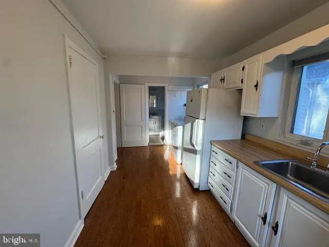 a kitchen with stainless steel appliances a stove a sink and a refrigerator