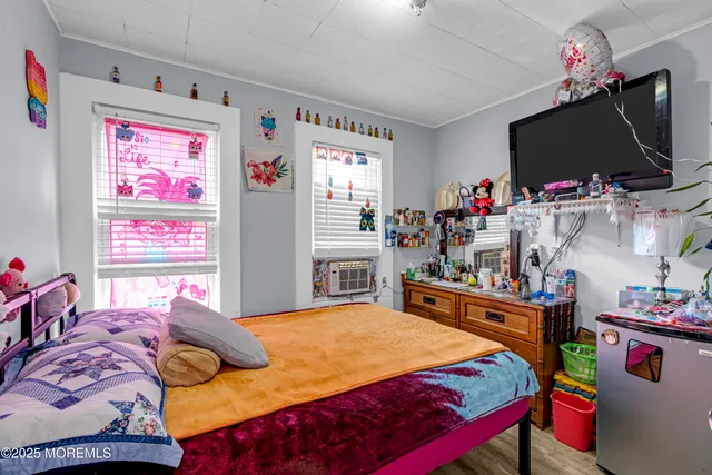 a bedroom with a bed and flat screen tv