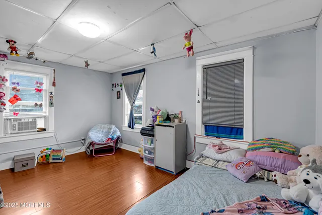 a bedroom with furniture and a wooden floor