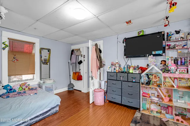 a bedroom with furniture and a flat screen tv
