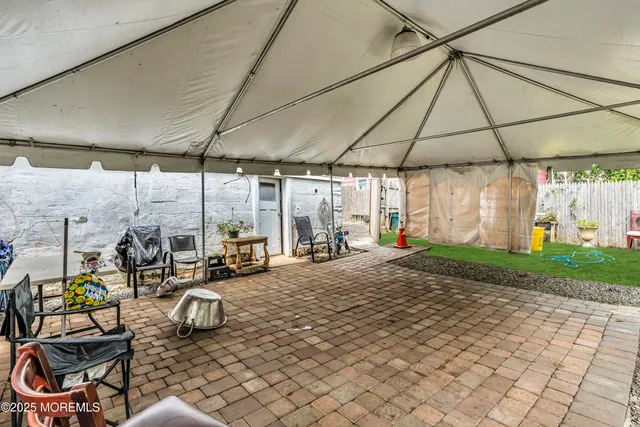 a building outdoor space with patio furniture and potted plants