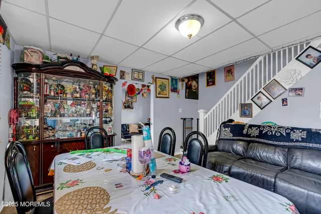 a living room with lots of furniture and kitchen view