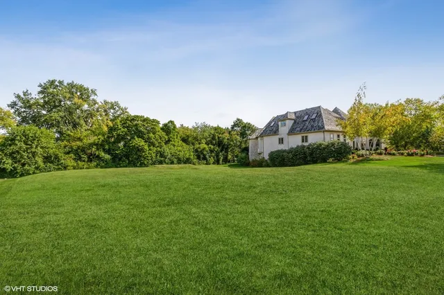 a yard with trees in the background