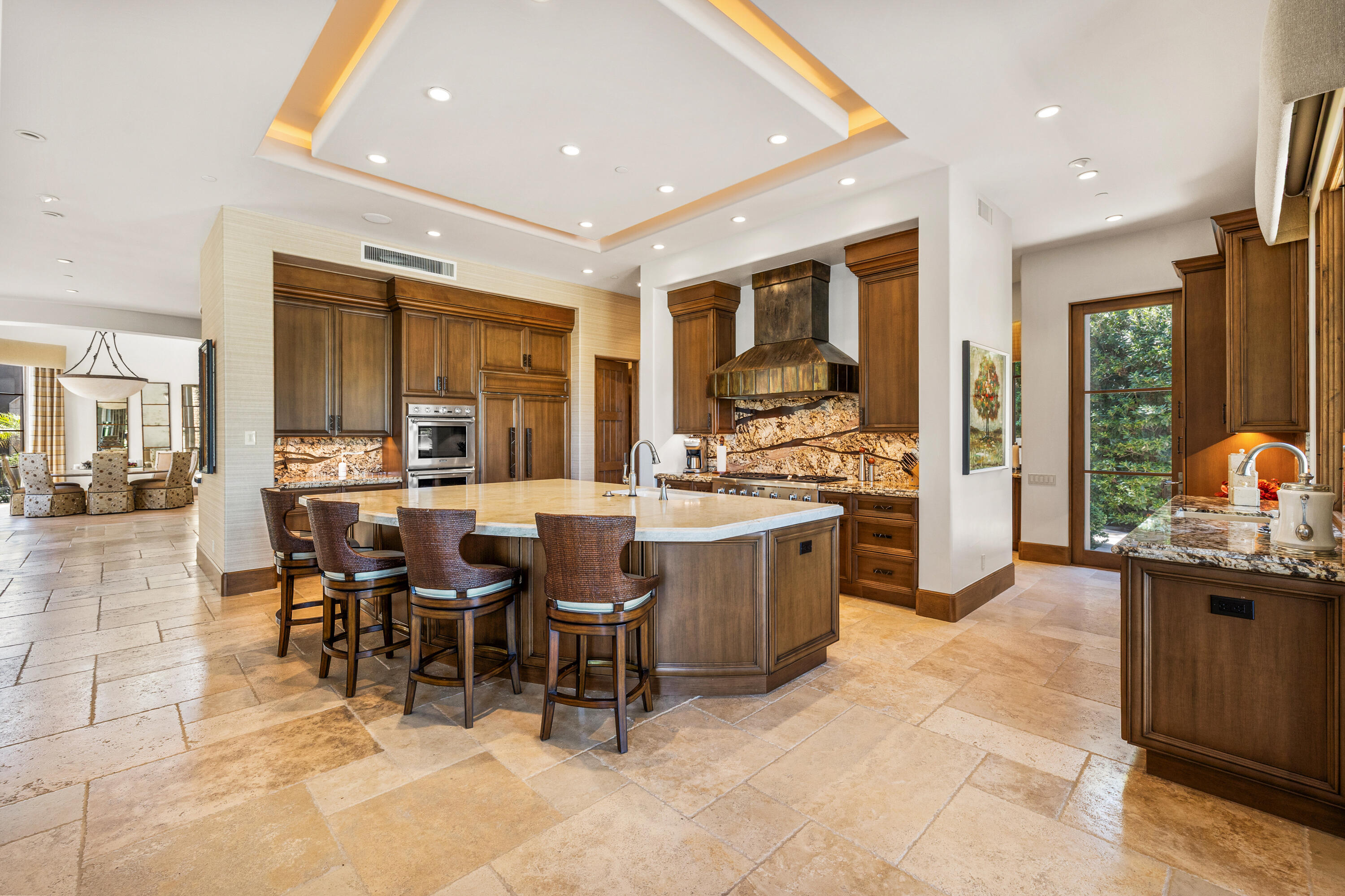 52711 Via Dona La Quinta, CA 92253 - Photo 12 of 61 a open dining room with stainless steel appliances kitchen island granite countertop a table and chairs in it