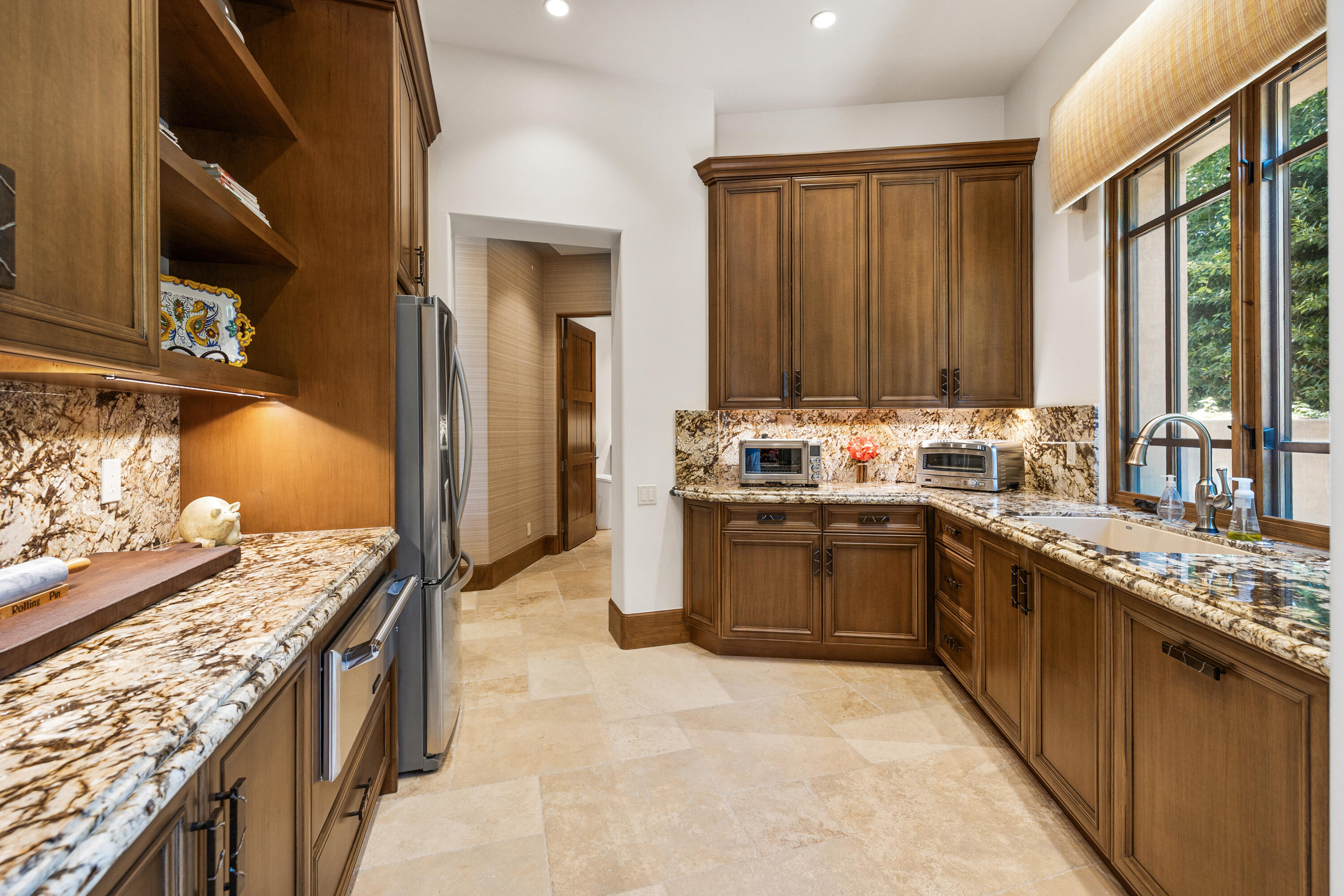 52711 Via Dona La Quinta, CA 92253 - Photo 16 of 61 a kitchen with stainless steel appliances granite countertop a stove a sink and a refrigerator
