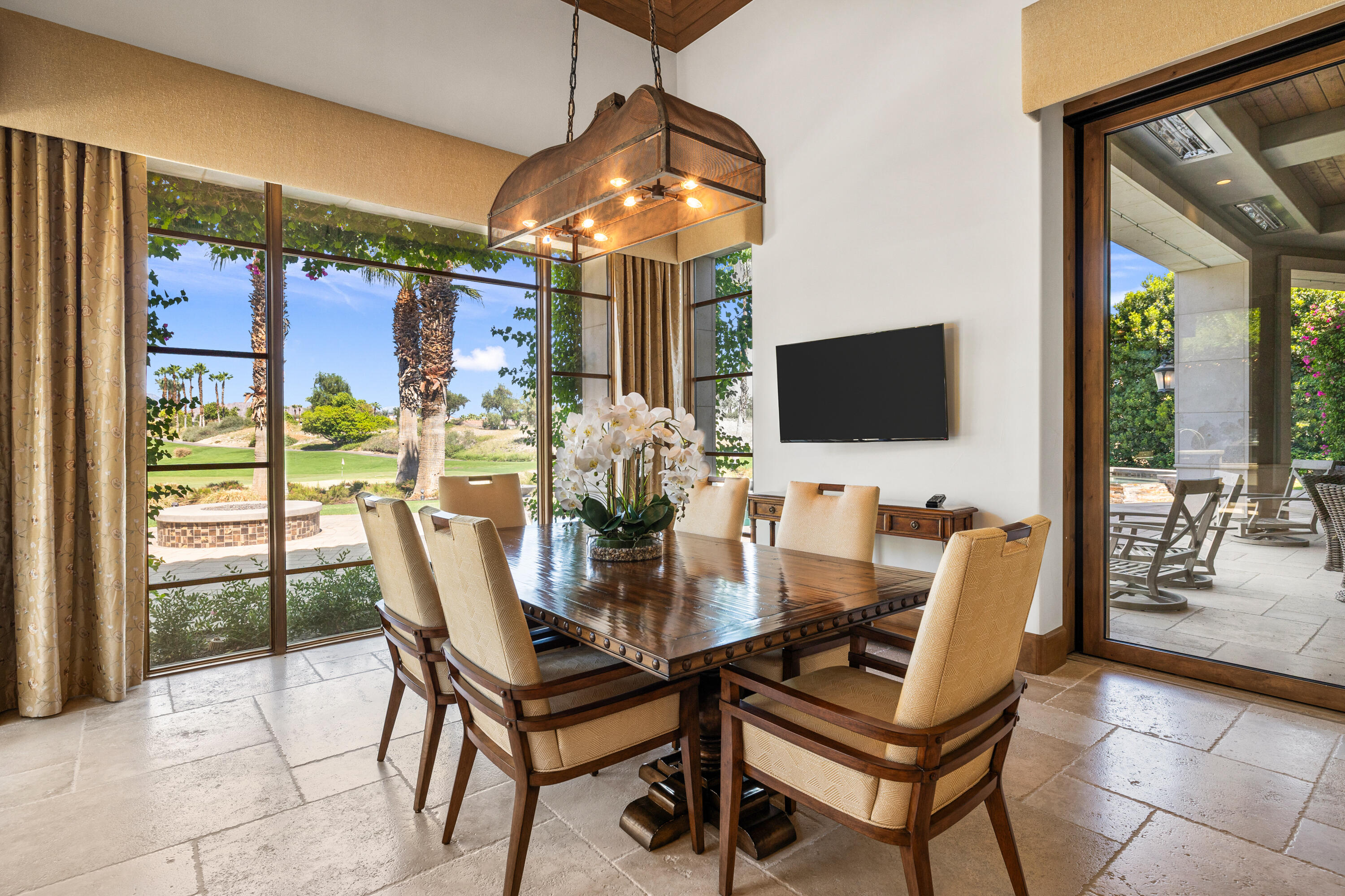 52711 Via Dona La Quinta, CA 92253 - Photo 20 of 61 a dining room with furniture and a floor to ceiling window