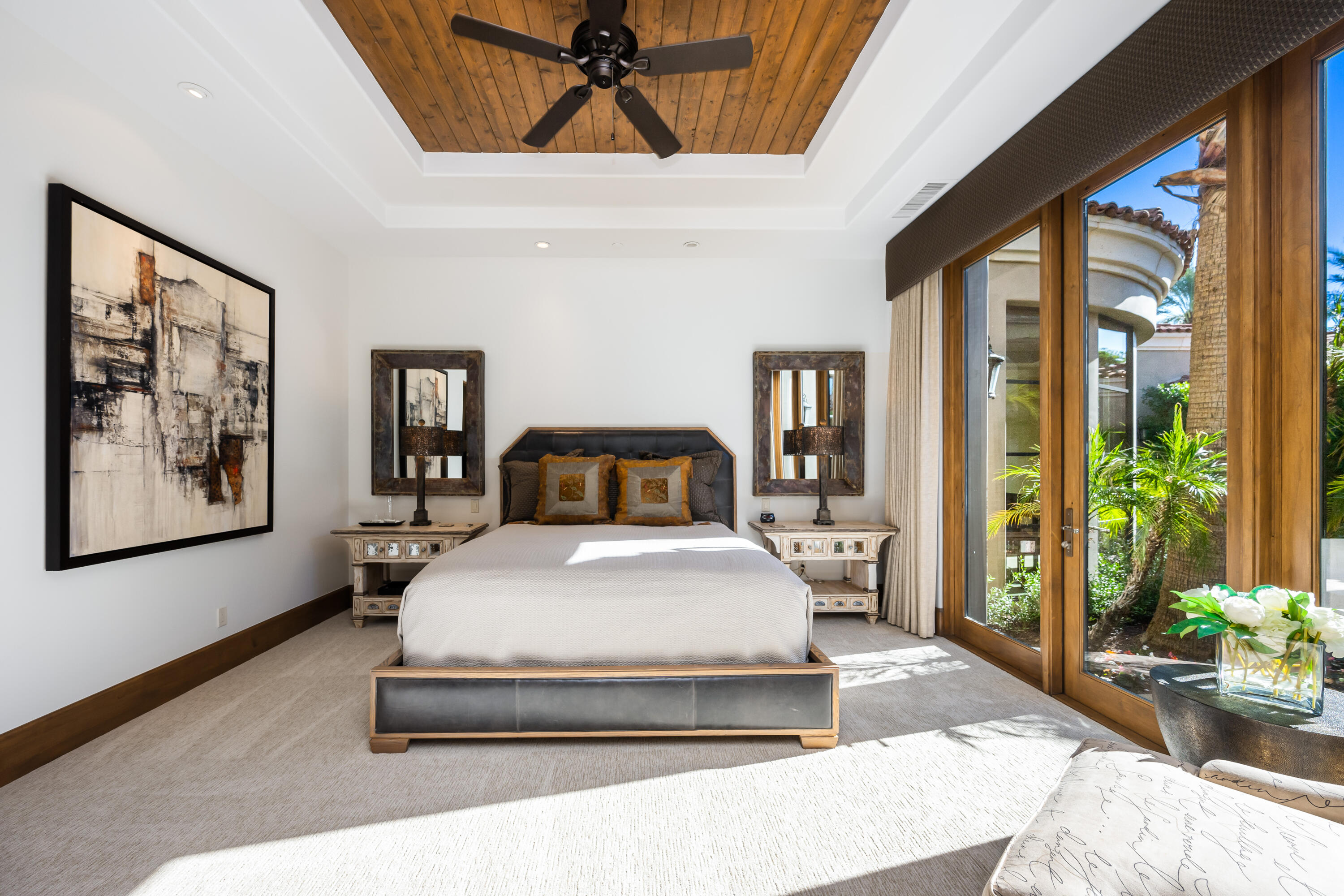 52711 Via Dona La Quinta, CA 92253 - Photo 35 of 61 a spacious bedroom with a large bed and a chandelier