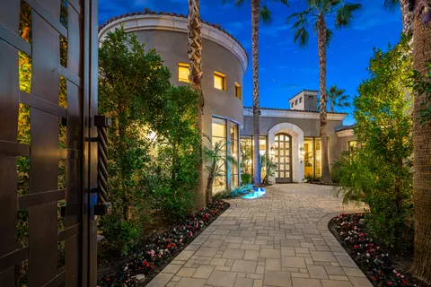 a view of a house with backyard sitting area and swimming pool