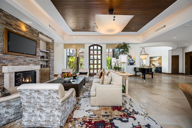 a living room with furniture a fireplace and a flat screen tv
