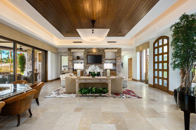 a open dining room with stainless steel appliances kitchen island granite countertop a table and chairs in it