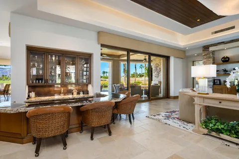 a kitchen with granite countertop a table and chairs in it