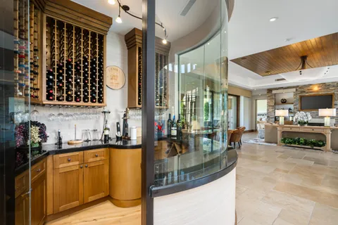 a dining hall with stainless steel appliances kitchen island granite countertop a stove and cabinets