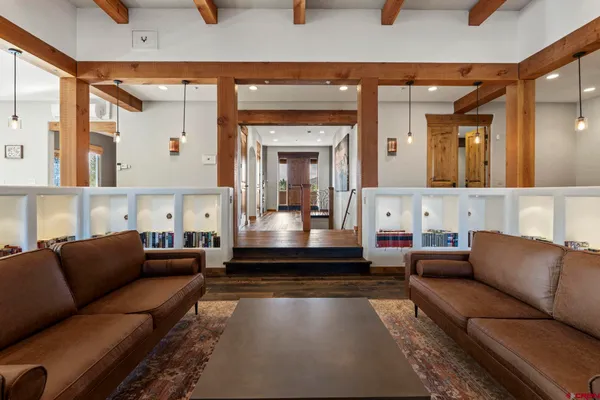 a kitchen with a stove a sink and a dining table with wooden floor