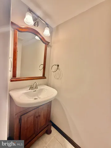 a bathroom with a sink vanity and a mirror
