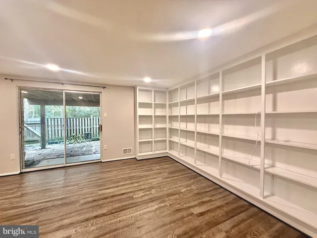 a view of wooden floor and windows in a room