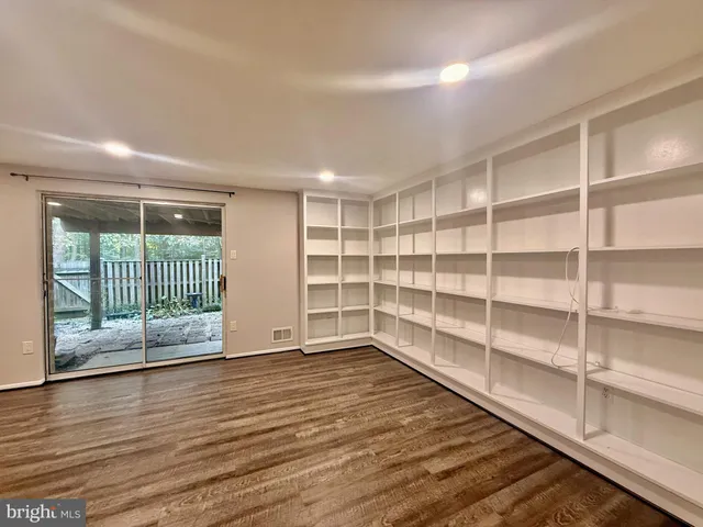 a view of wooden floor and windows in a room