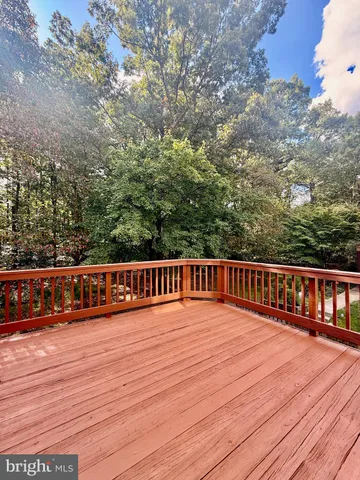 a view of balcony with wooden floor and fence