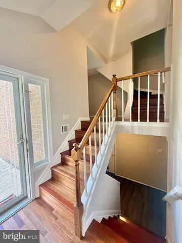 a view of staircase with lots of windows and wooden floor