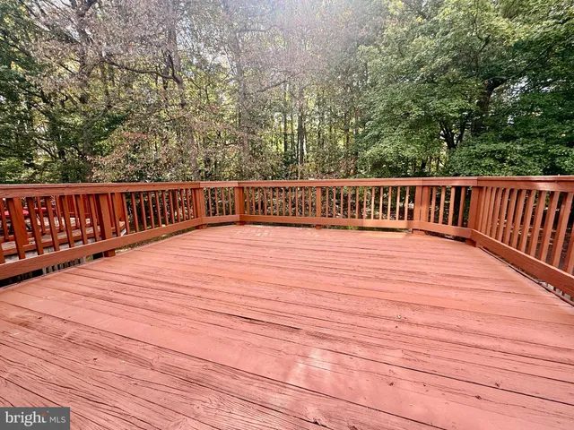 a view of balcony with wooden floor and fence