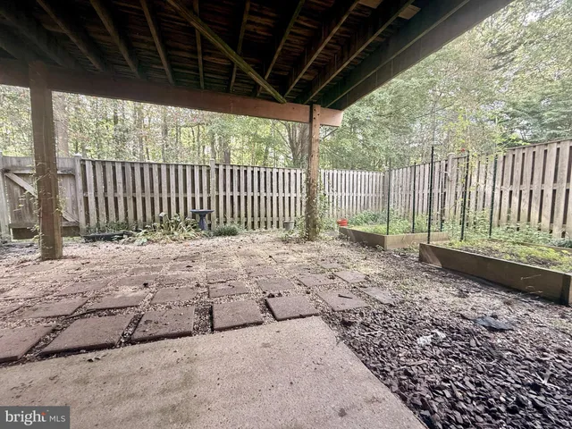 a view of a backyard with wooden fence