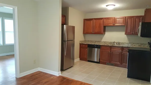 a kitchen with a refrigerator sink and cabinets