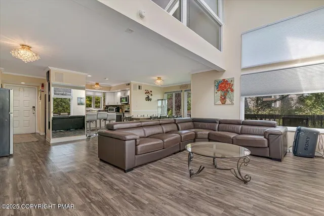 a front view of a house with a yard and potted plants
