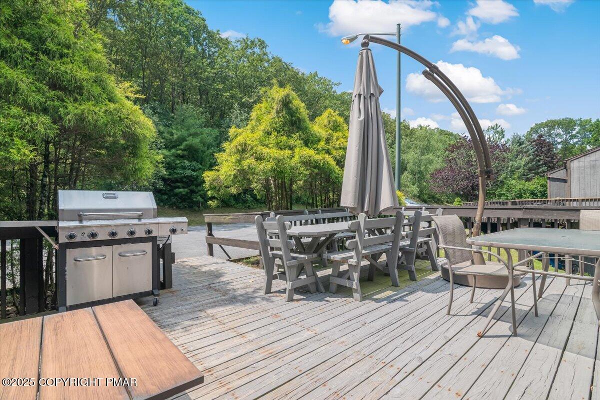 268 Big Pocono Pass Tannersville, PA 18372 - Photo 4 of 66 a view of a patio with table and chairs barbeque with wooden floor and fence