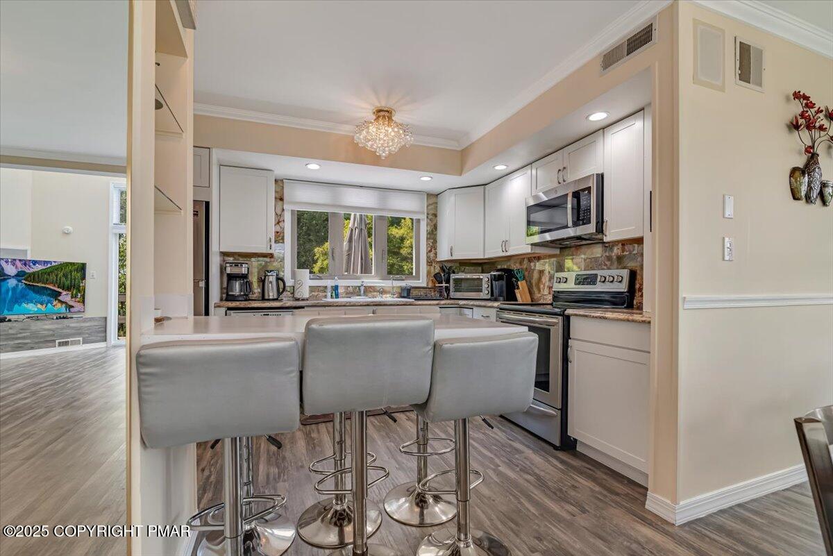 268 Big Pocono Pass Tannersville, PA 18372 - Photo 8 of 66 a kitchen with cabinets and wooden floor