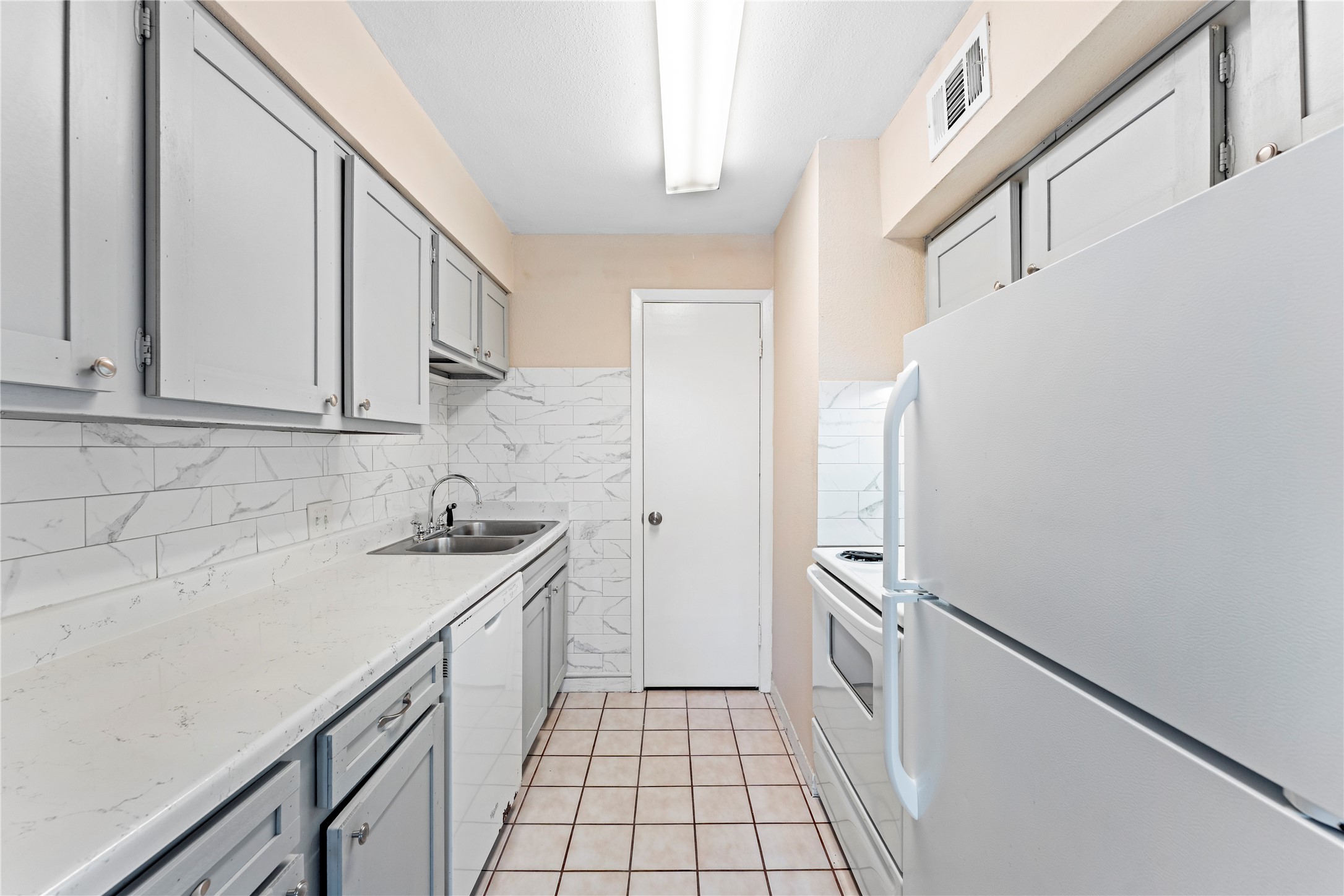 3316 Burke Road, Unit 43 Pasadena, TX 77504 - Photo 8 of 15 a kitchen with a sink and refrigerator