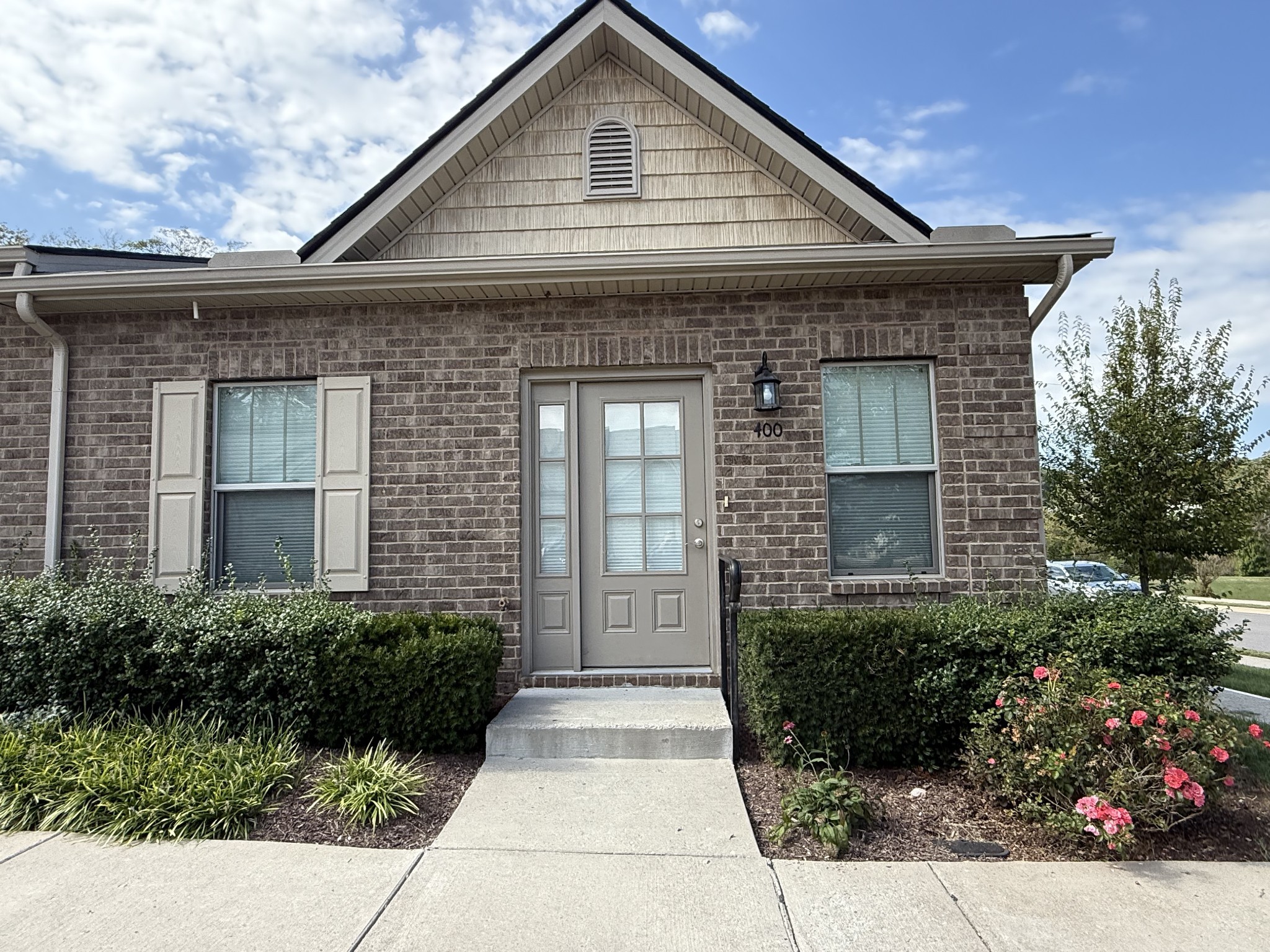 a front view of a house with garden
