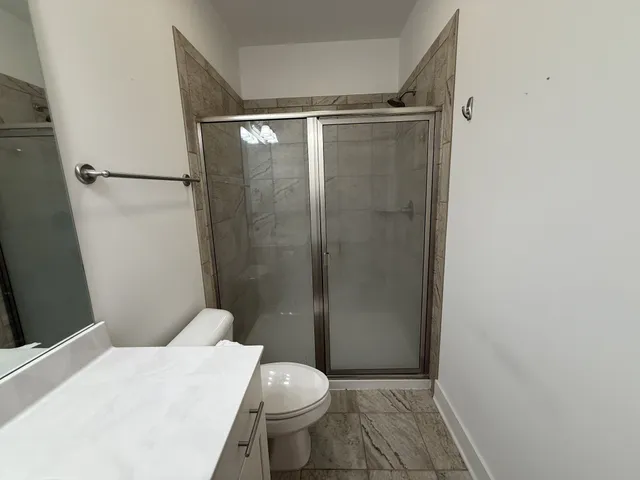 a bathroom with a shower and a toilet