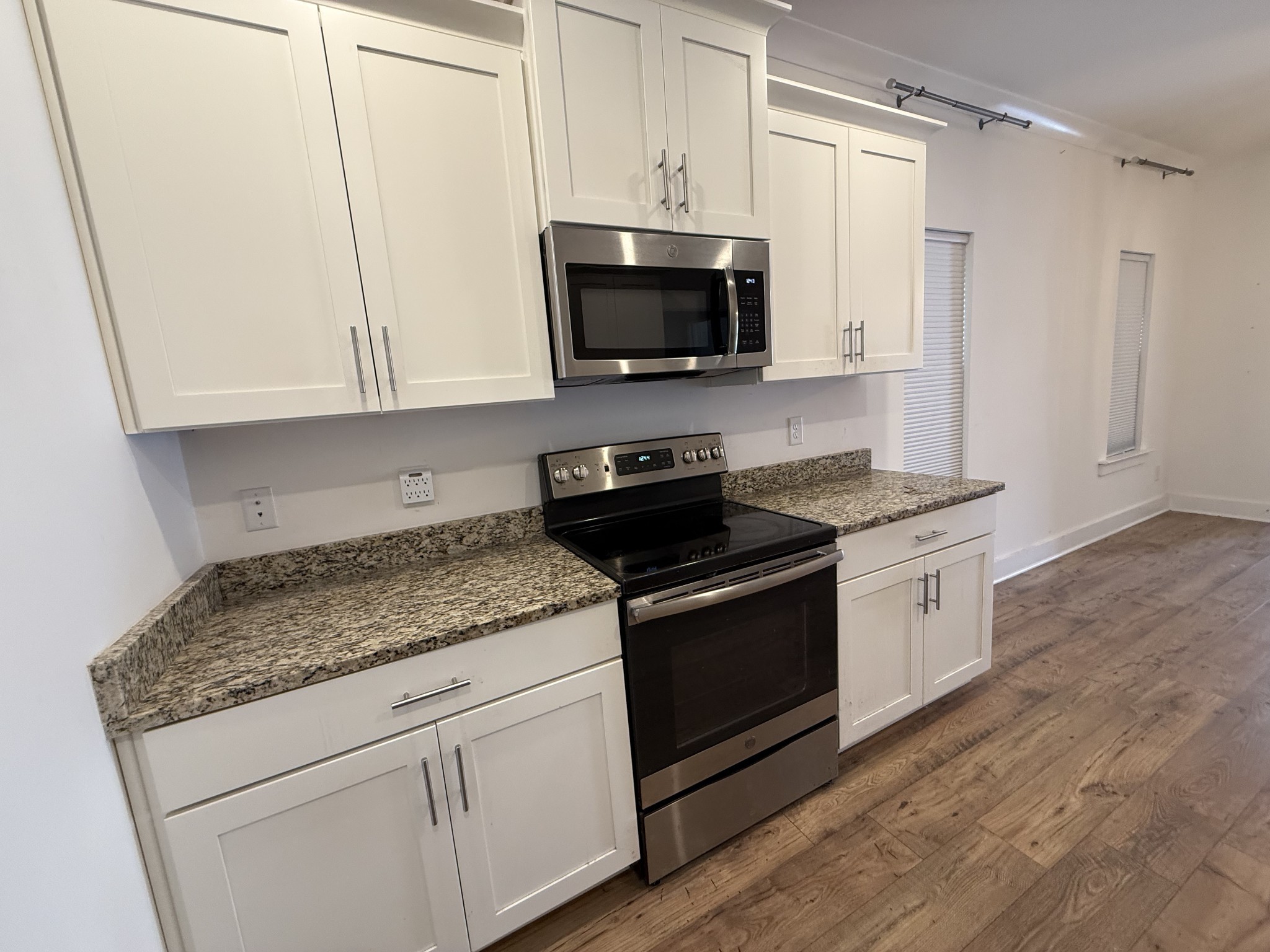 400 Buchanan Court Columbia, TN 38401 - Photo 10 of 21 a kitchen with stainless steel appliances granite countertop a stove a microwave and a white cabinets