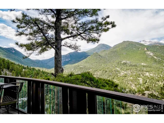 a view of mountain with wooden deck