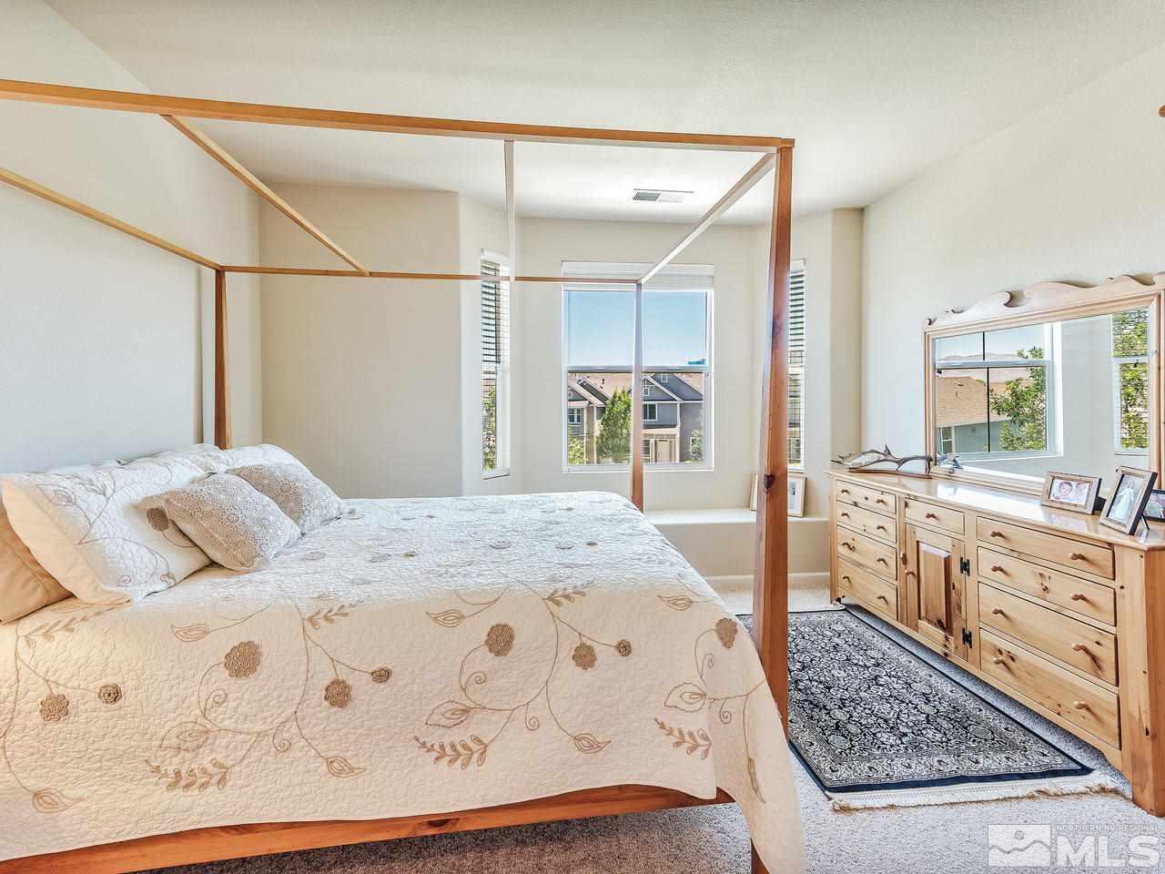 240 Gramercy Lane Reno, NV 89509 - Photo 13 of 18 a bedroom with a large bed a rug and dresser