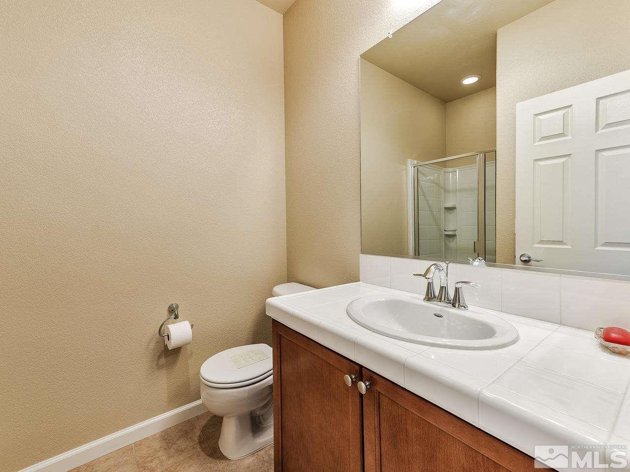 240 Gramercy Lane Reno, NV 89509 - Photo 16 of 18 a bathroom with a sink a toilet and mirror