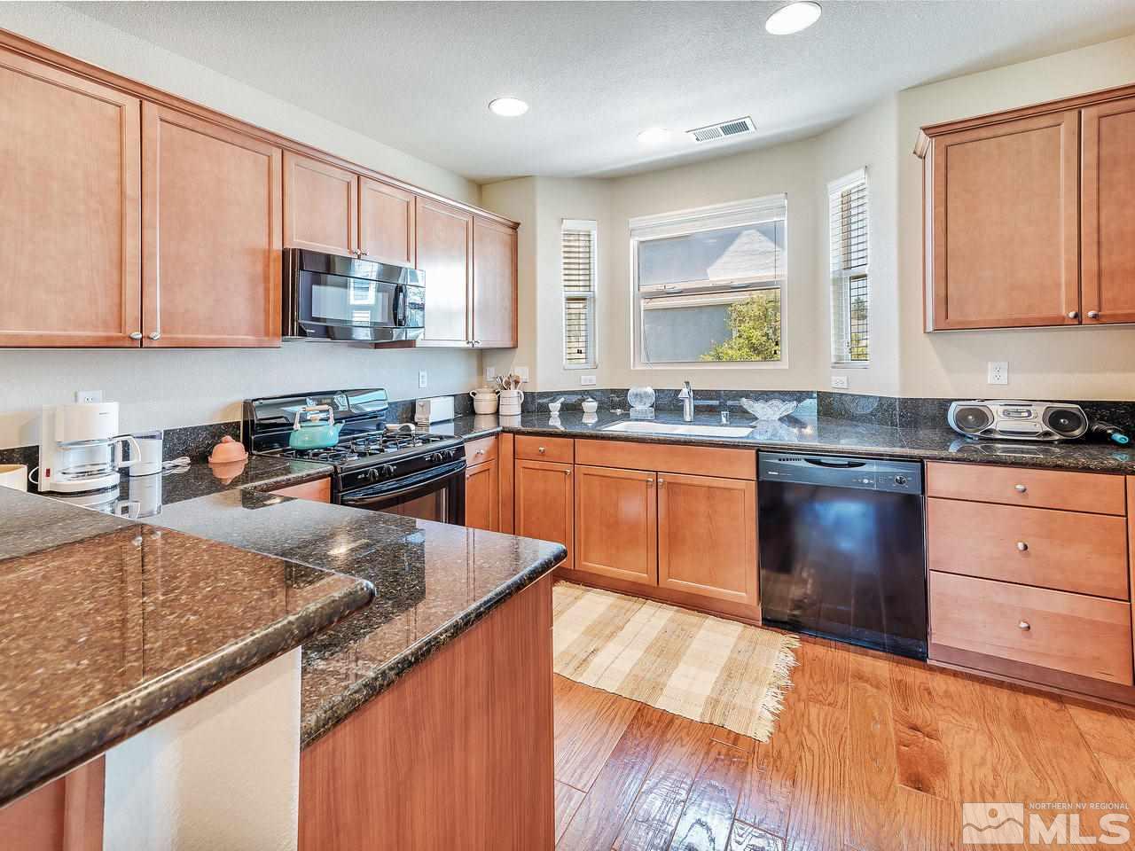 240 Gramercy Lane Reno, NV 89509 - Photo 5 of 18 a kitchen with stainless steel appliances granite countertop a sink a stove and cabinets