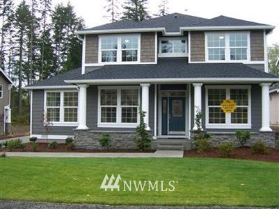 4687 Rutherford Circle Southwest Port Orchard, WA 98367 - Photo 1 of 1 a front view of a house with garden