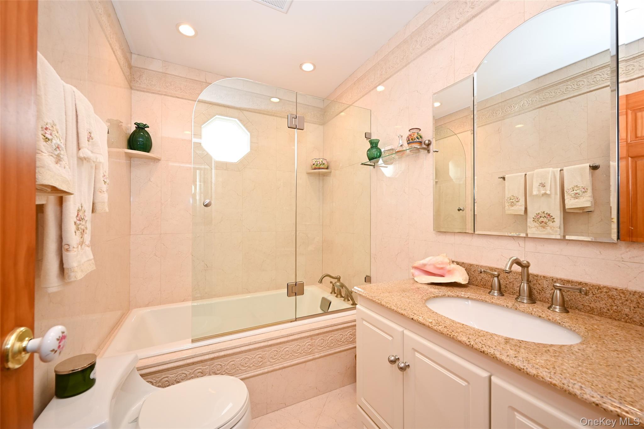 45-18 166th Street Queens, NY 11358 - Photo 12 of 20 a bathroom with a granite countertop sink mirror toilet and bathtub