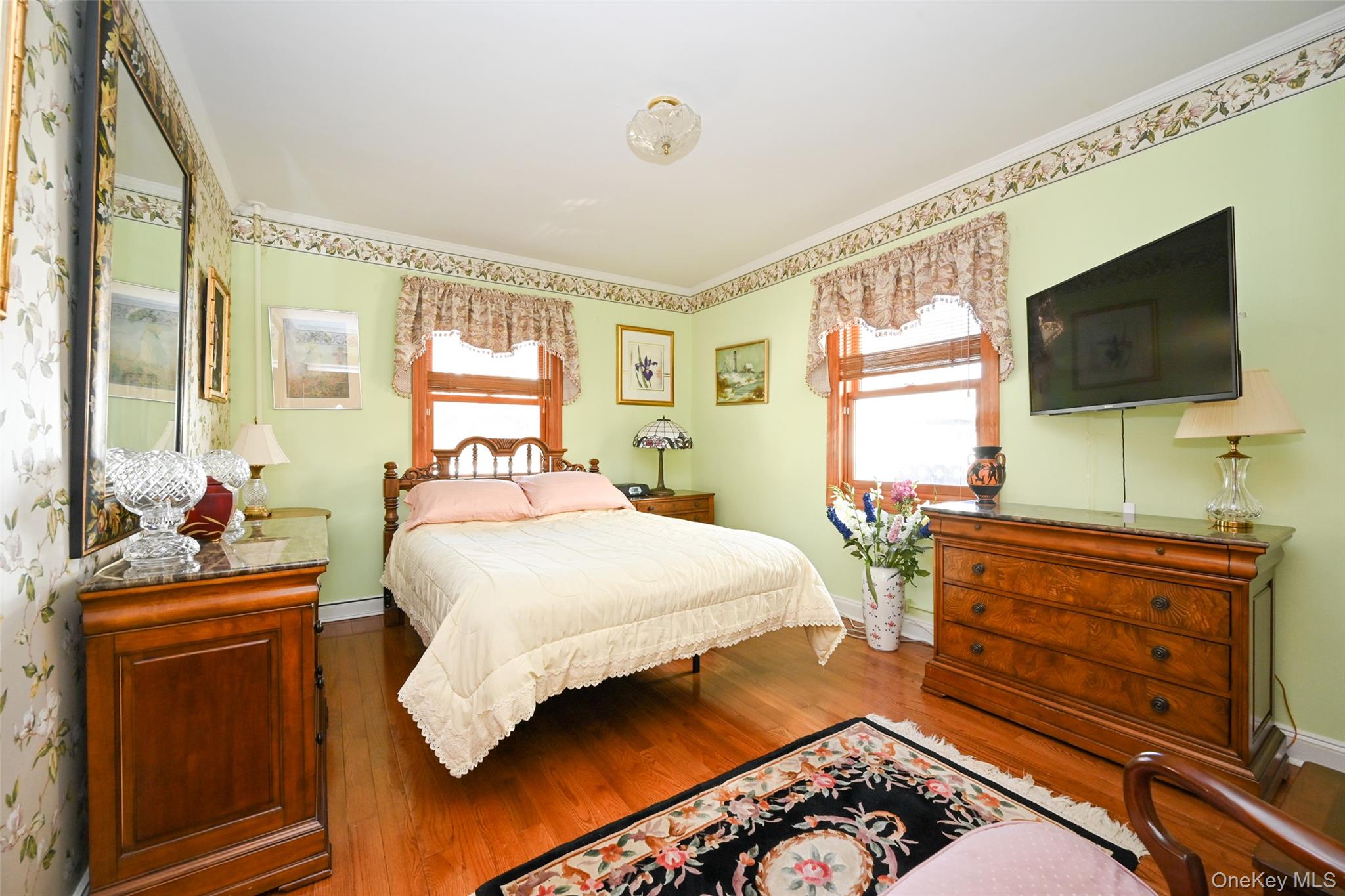 45-18 166th Street Queens, NY 11358 - Photo 13 of 20 a bedroom with a bed and flat screen tv
